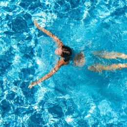 a woman swimming in a pool