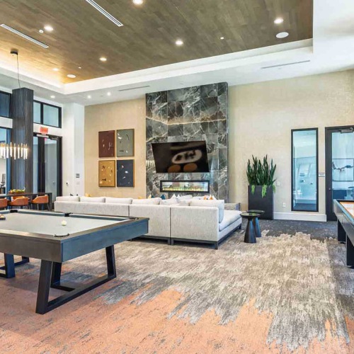 high ceilings in clubroom with billiards and shuffleboard tables