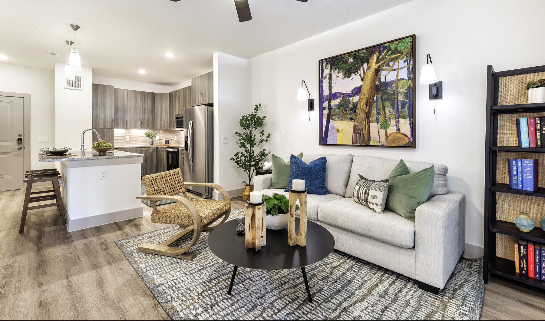 communal space with beige couch and kitchen in the foreground