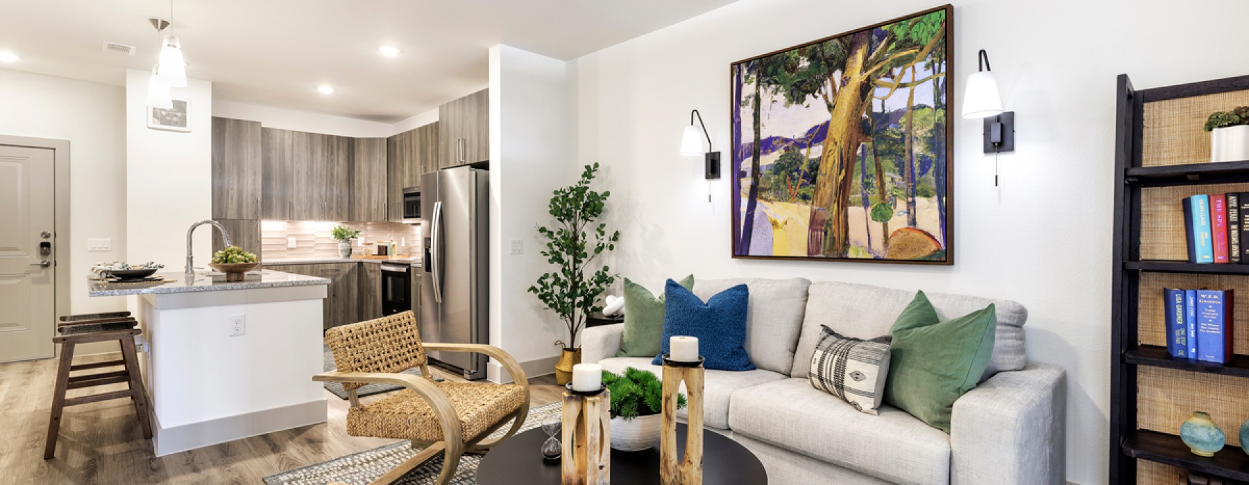 living area with beige couch with kitchen in the background