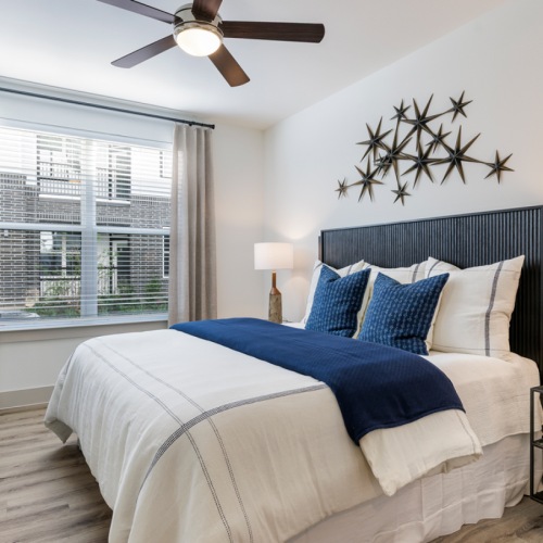 Spacious bedroom with queen size bed with blue pillows