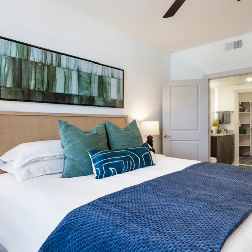 Spacious bedroom with queen size bed with blue pillows