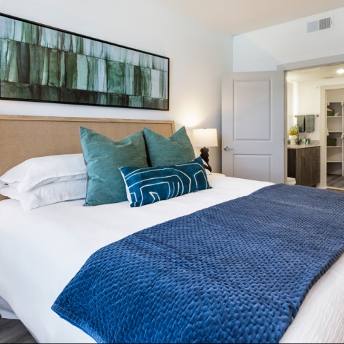 Spacious bedroom with queen size bed with blue pillows